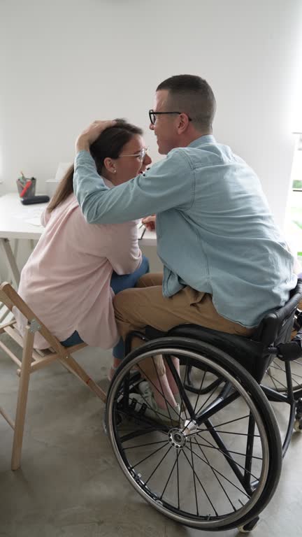A participant and worker reviewing care notes on a tablet together